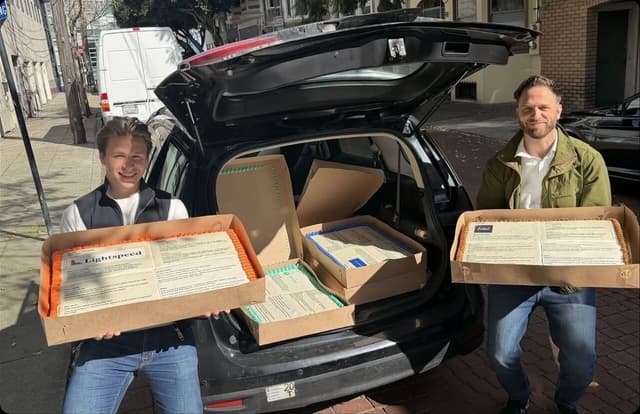 Boxed coldcakes coming out of a car on a San Francisco street, on the way to be hand-delivered